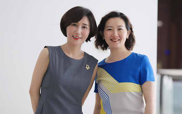 Two ladies smiling